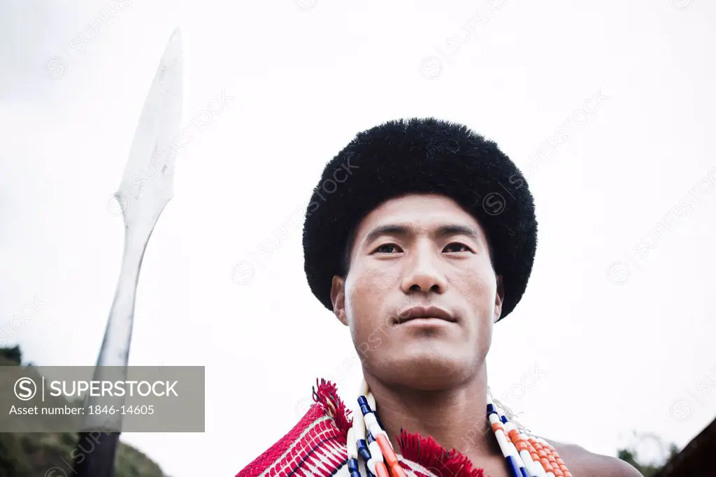 Naga tribal warrior standing with spear, Hornbill Festival, Kohima, Nagaland, India