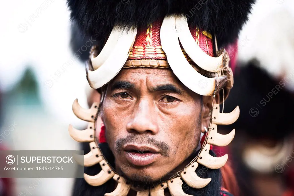 Portrait of Naga tribesman in traditional outfit during the annual Hornbill Festival at Kisama, Kohima, Nagaland, India