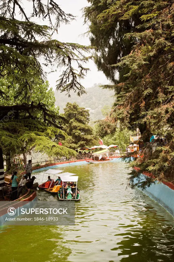 Tourists boating in an artificial canal at Company Bagh, Mussoorie, Uttarakhand, India