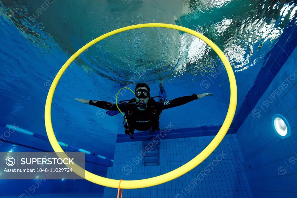 Dive training, scuba diver balancing in a swimming pool, Nuremberg, Bavaria, Germany