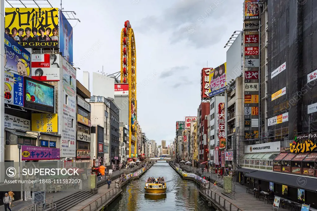 Tourist boat on the Dotonbori canal, illuminated advertising and many signs, Dotonbori, Osaka, Japan, Asia