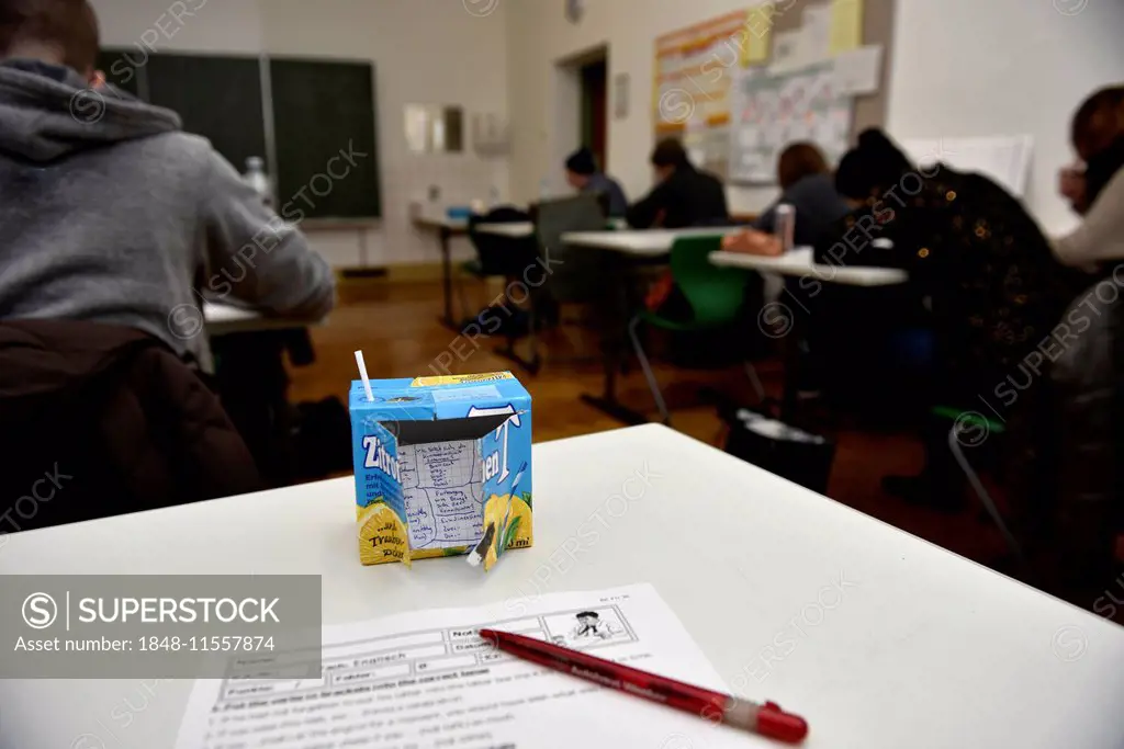 Cheat sheet or crib, hidden in a Tetrapak, pupils taking a test in a classroom