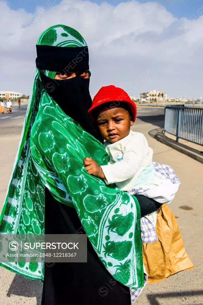 Fully veiled Muslim woman and her child, Massawa, Eritrea