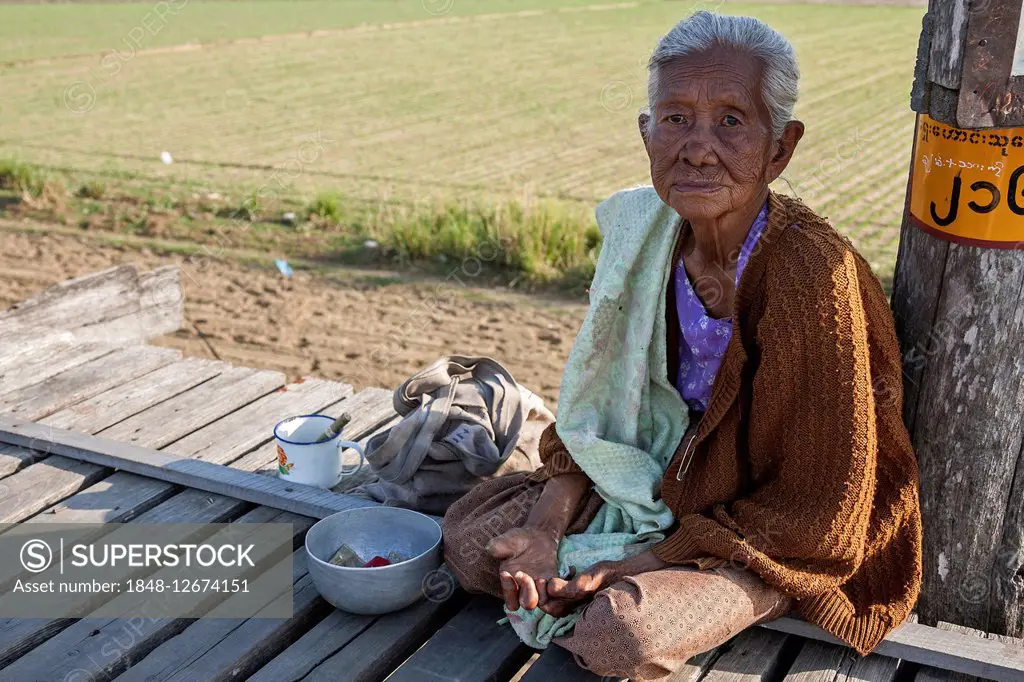 Native leper woman sitting on the U Bein Bridge, begging, Amarapura, Division Mandalay, Myanmar