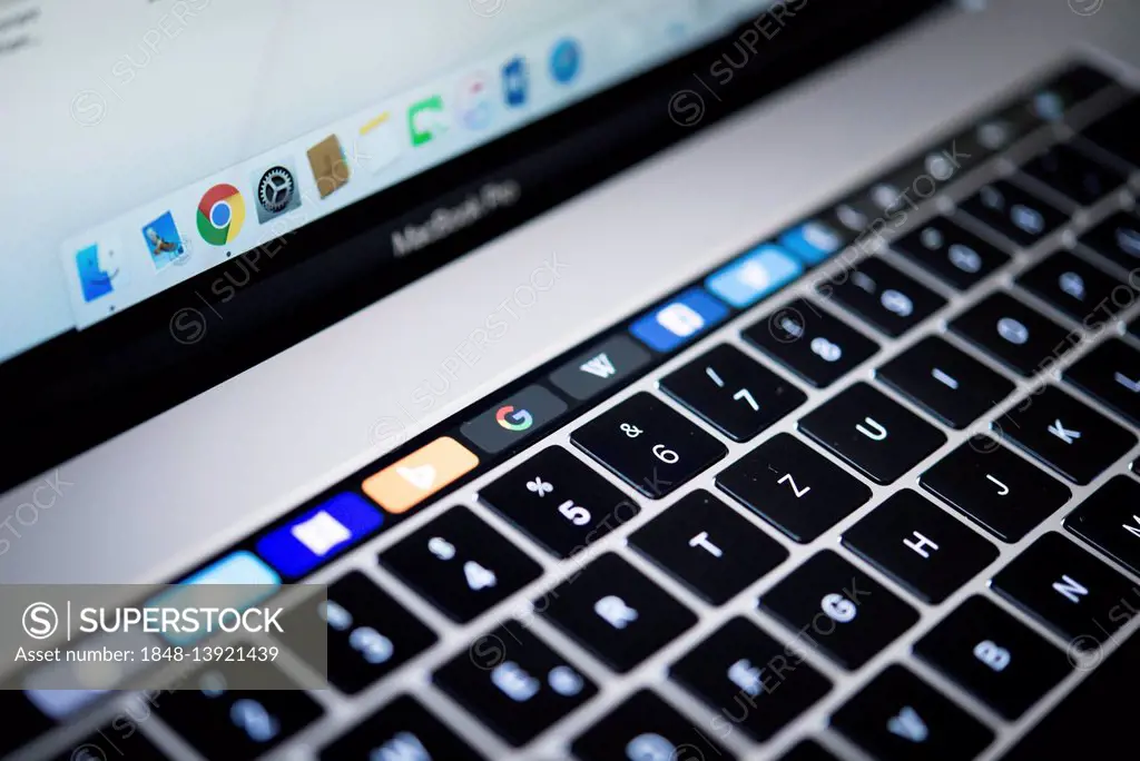 Backlit keyboard and Touch Bar showing websites, laptop, Apple MacBook Pro, close-up