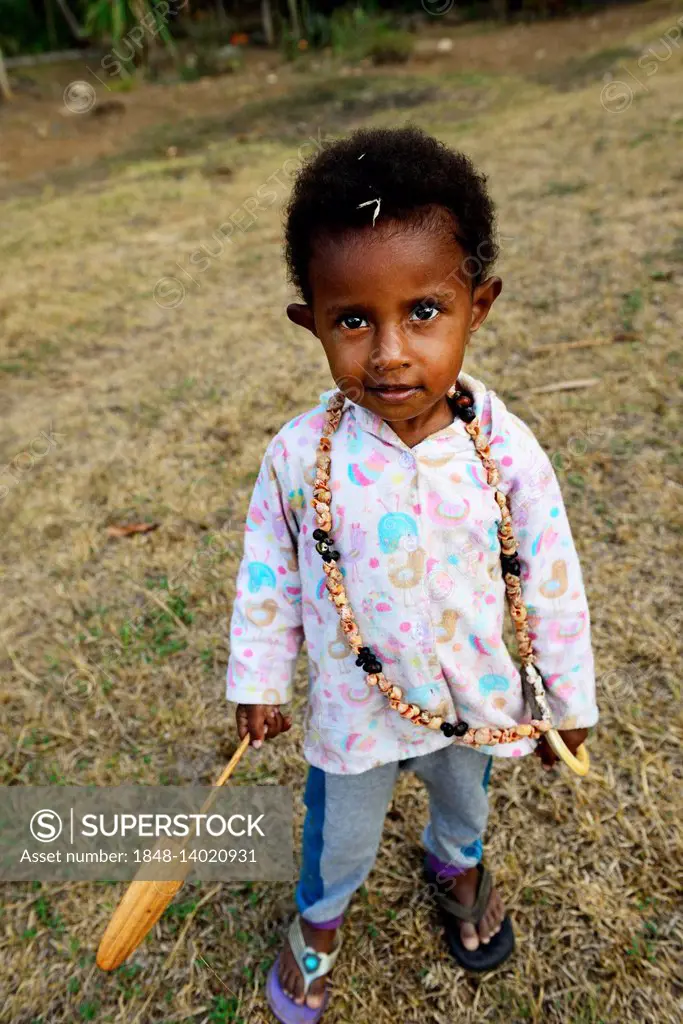 Korafe tribe, child with wooden toy paddle, Korafe tribe, Tufi, Papua New Guinea