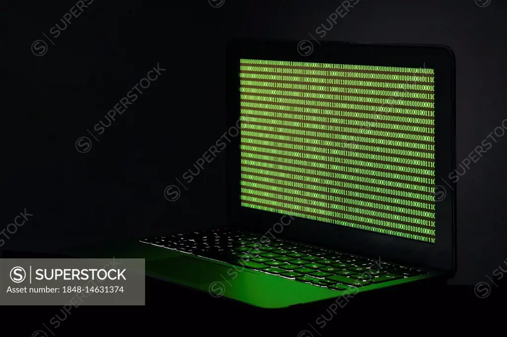 Symbol image cybercrime, laptop with digital binary code