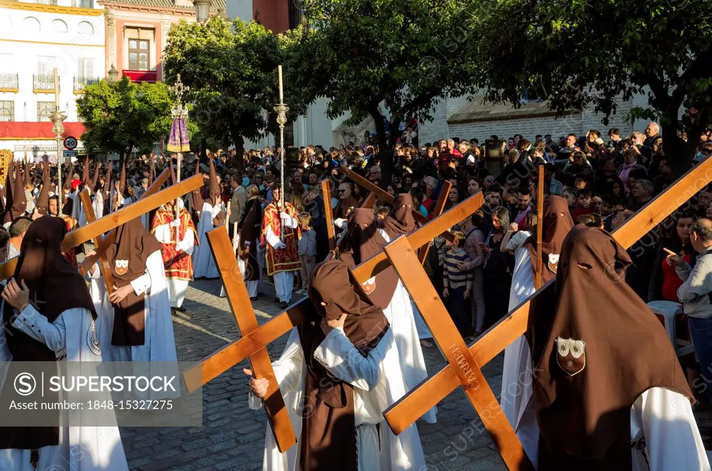 Penitents with cross at the Semana Santa, the Holy Week, Seville, Andalusa, Spain