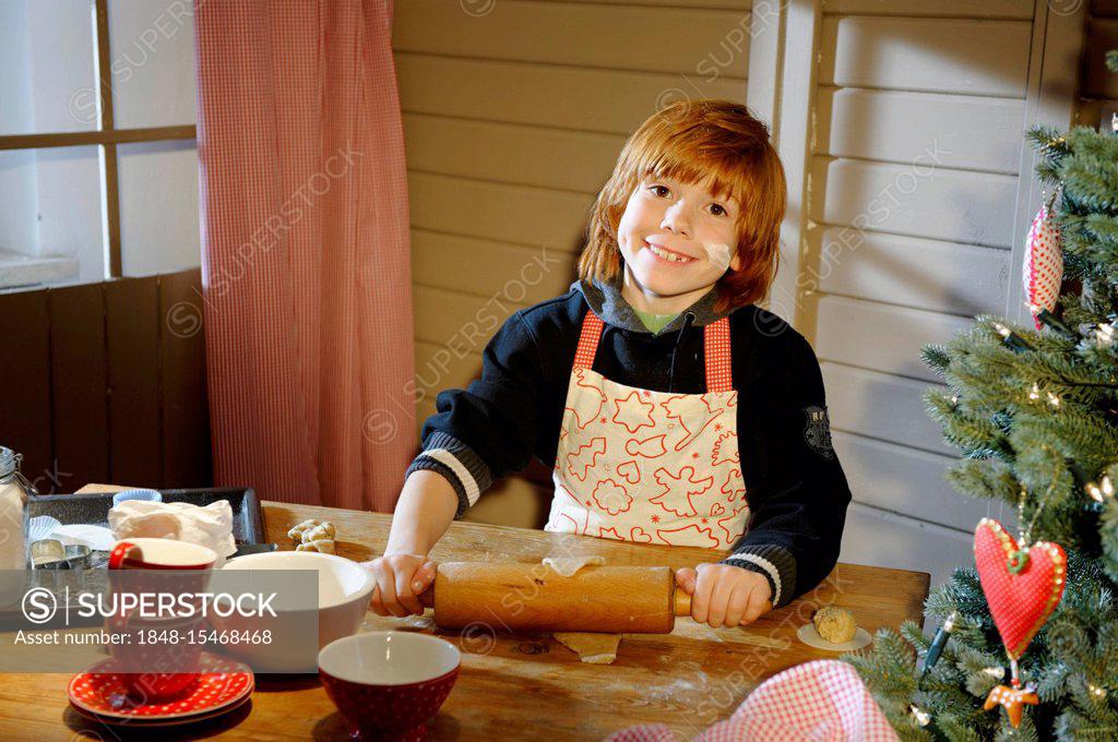 Christmas bakery, boy baking cookies - SuperStock