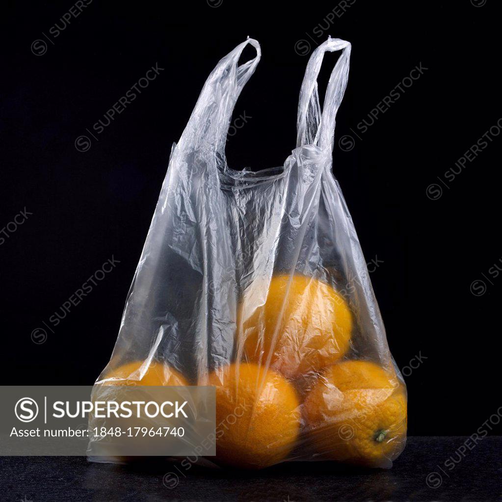 Fresh tangerines with leaves in a plastic bag Stock Photo