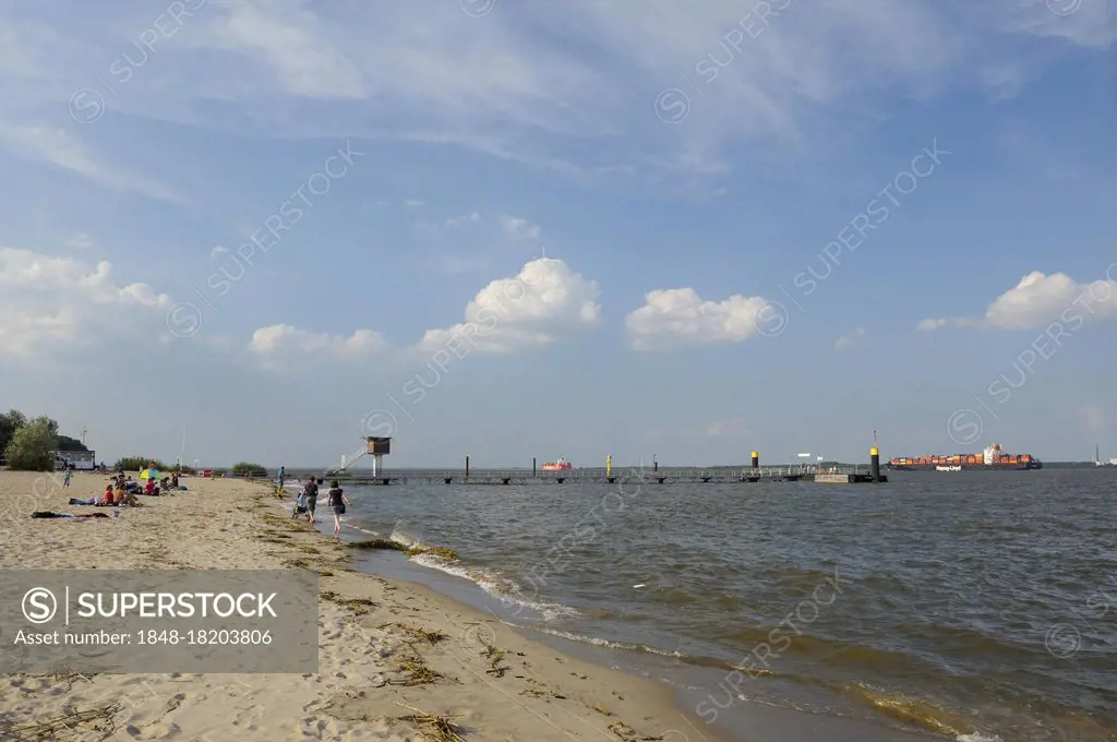 Elbe island Krautsand, peninsula at the Elbe shore between Cuxhaven and Hamburg, beach at the Elbe shore and container ship on the Elbe, August, Kehdi...