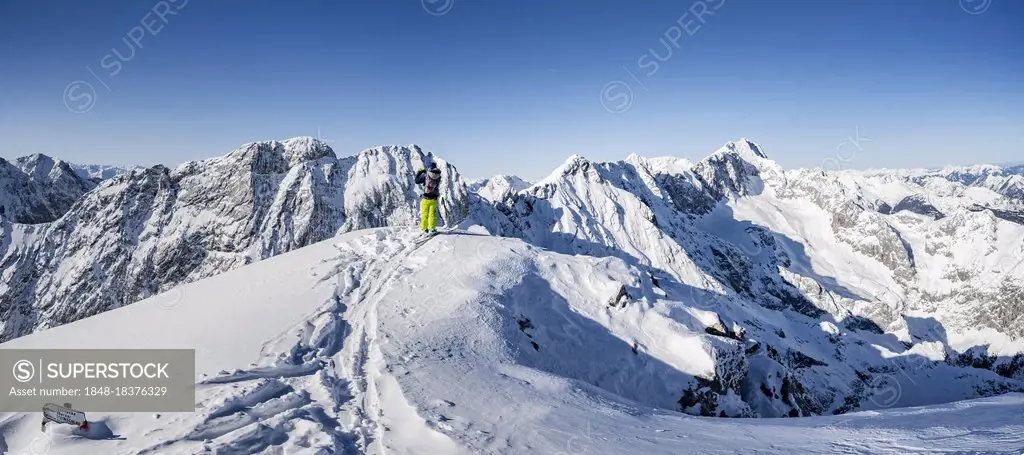 Alpspitz summit, ski tourers on ski tour to the Alpspitze, Bernadeinkopf, view over the Wetterstein mountains with snow in winter, Garmisch-Partenkirc...