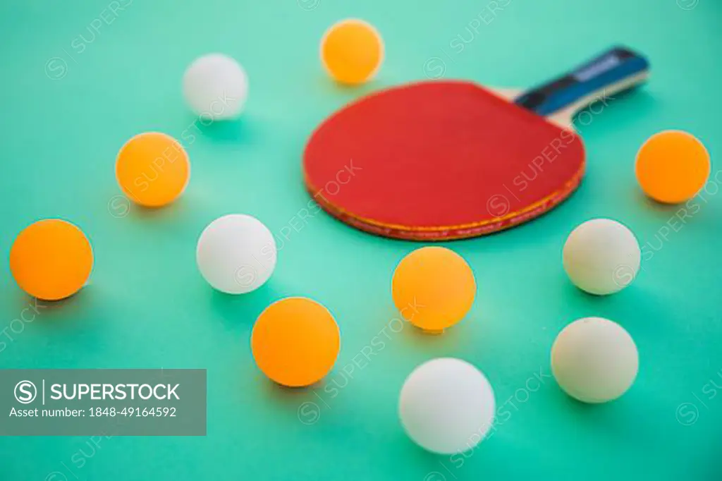 Ping pong balls wooden racket turquoise background