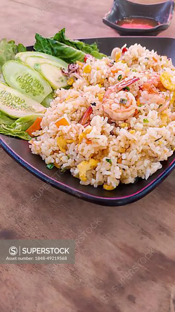 Vertical view of a plate of Khmer fried rice with shrimps or Bai