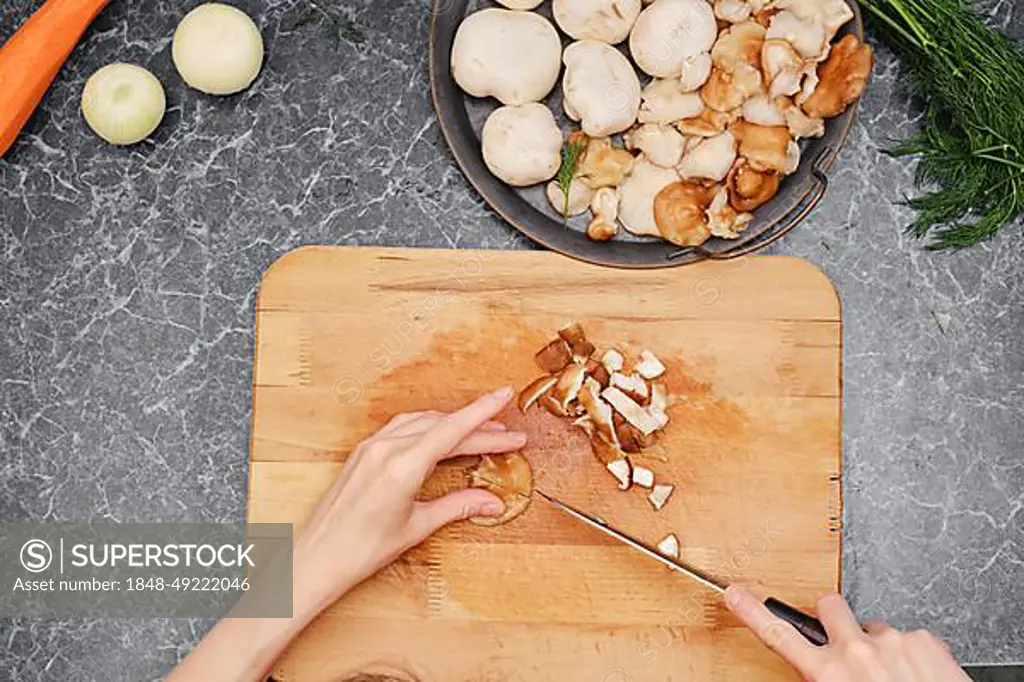 Unrecognizable woman cutting vegetables while making healthy food