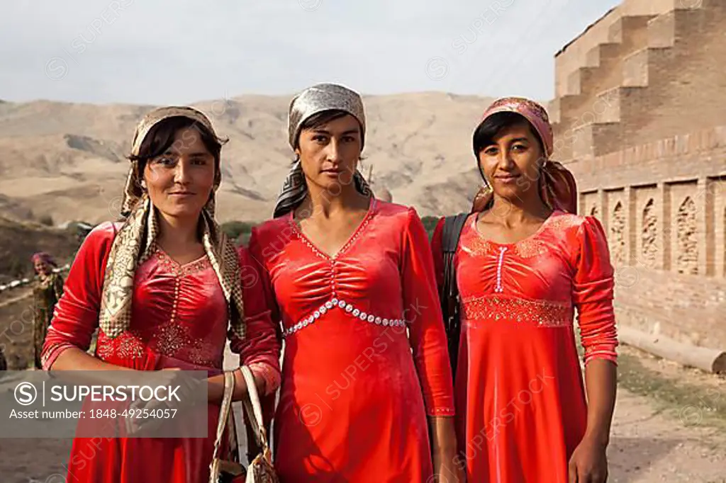 Women with red dresses, Uzbekistan, Asia