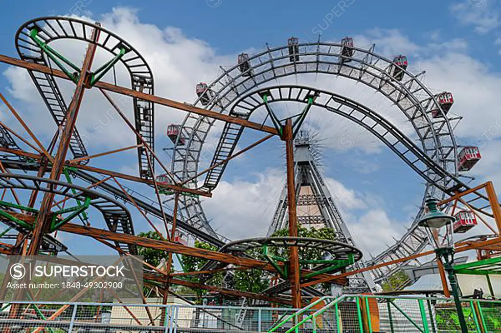 Rusty scaffolding and rails of an old roller coaster in the back