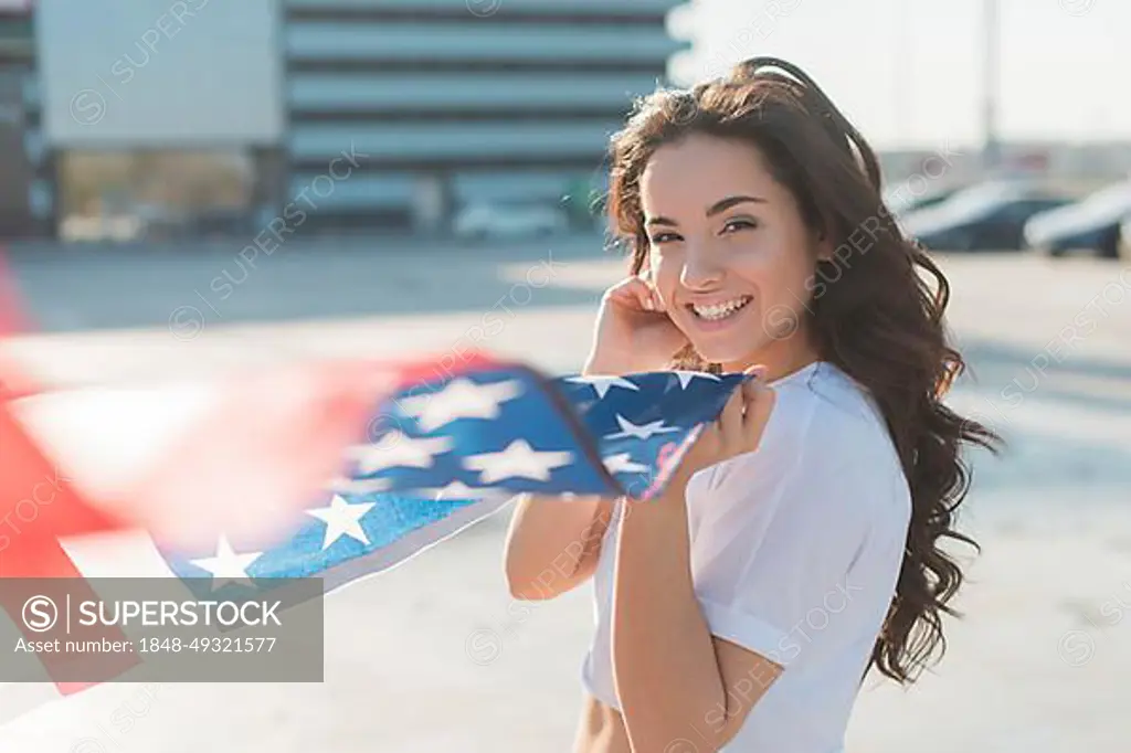 Beautiful woman holding big usa flag