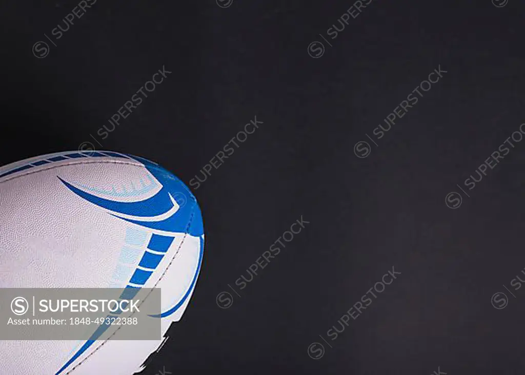 Close up white rugby ball black background