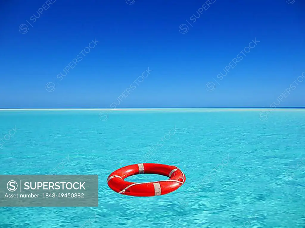 Red lifebuoy floating on turquoise blue water in the sea, ocean, location unknown