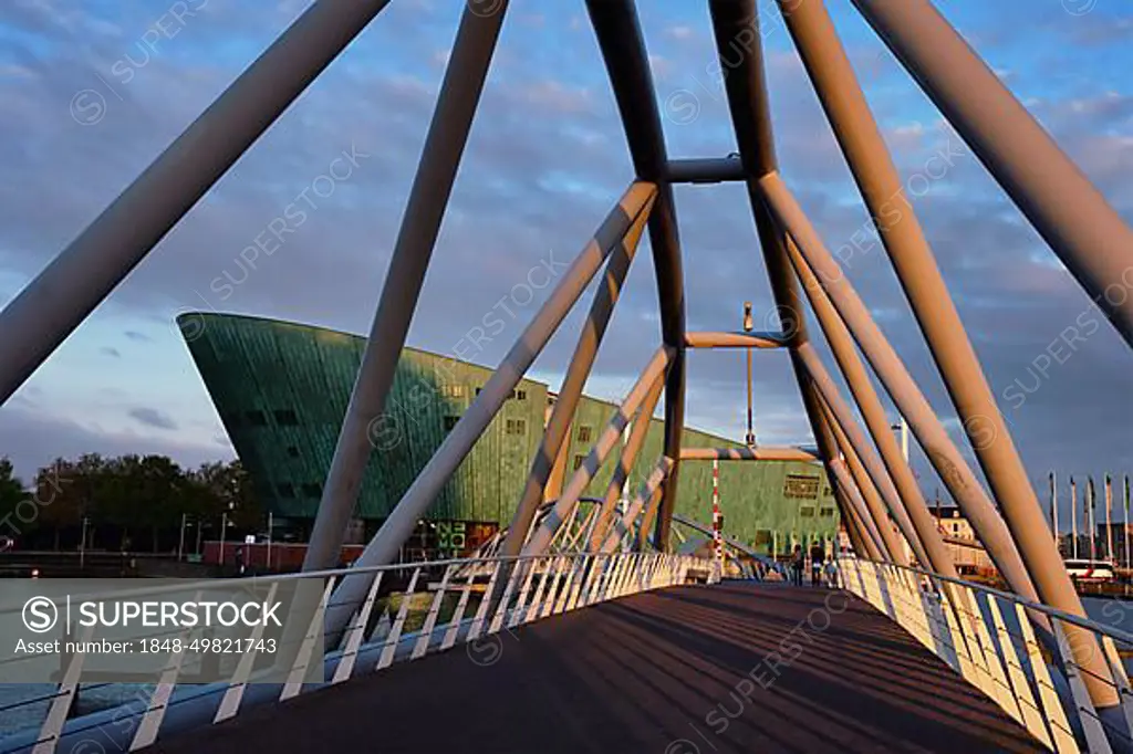 AMSTERDAM, NETHERLANDS, MAY 9, 2017: NEMO Science museum and Mr. J. van der Veldebrug bridge. It is the largest science center in Netherlands with over 500000 visitors per year