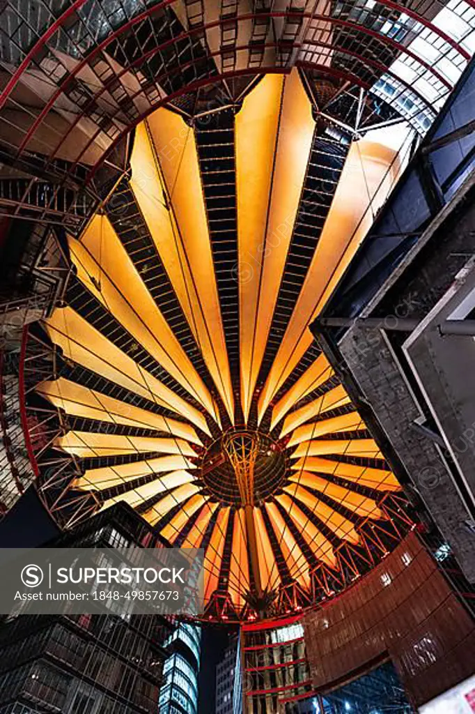 Modern roof construction with warm orange lighting in the city, Sony Center, Berlin, Germany, Europe