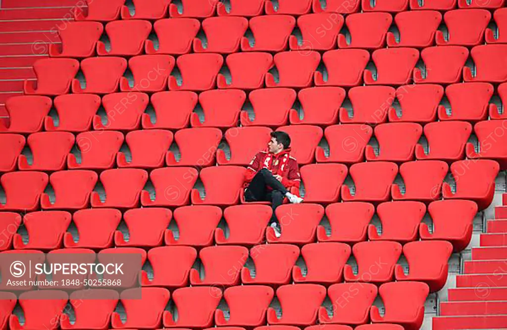 Lone Bayern fan sits in the stands, Allianz Arena, Munich, Bavaria, Germany, Europe