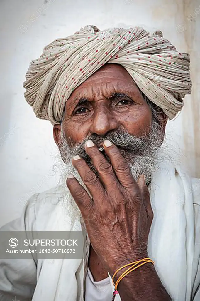 Elderly Indian man resting on a bed, Jaisalmer, Rajasthan, India, Asia