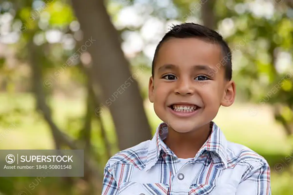 Handsome young hispanic boy having fun in the park