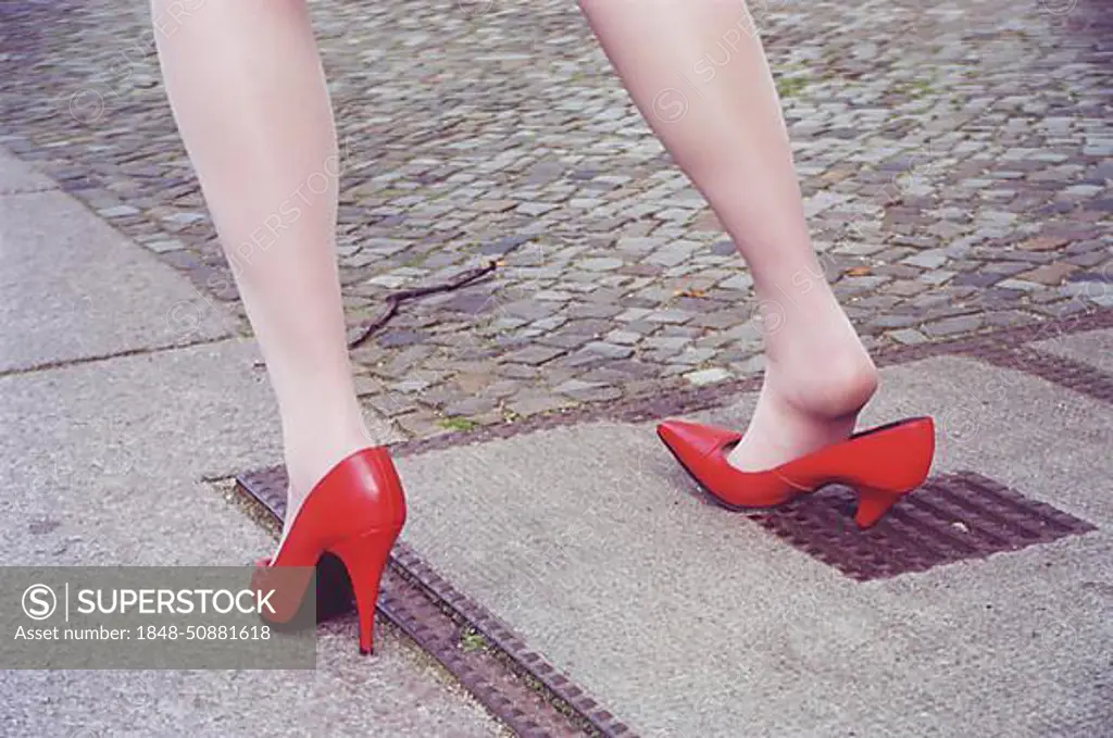 Misfortune, woman gets stuck in a hole with high heels, Berlin, Germany, Europe