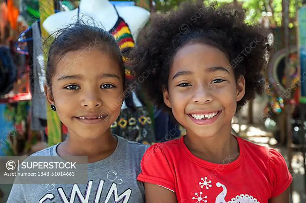 Two laughing native girls, portraits, Samara, Nicoya Peninsula, Guanacaste Province, Costa Rica, Central America