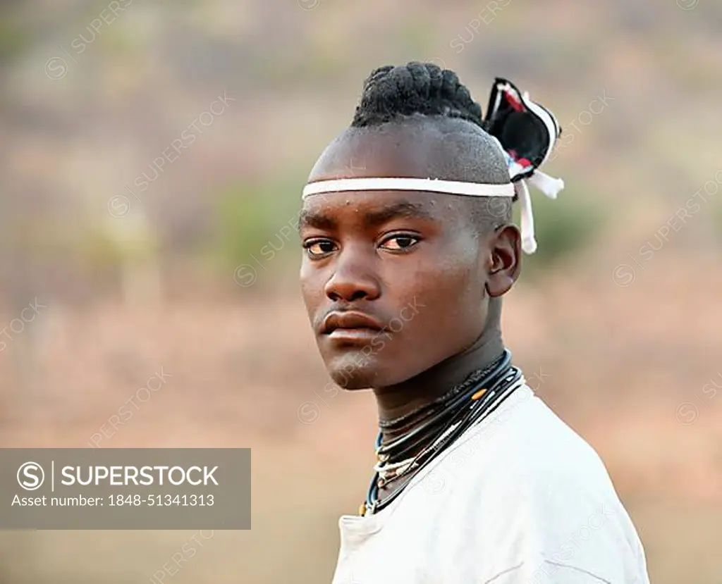 Young Himba man with traditional hairstyle, Portrait, Kaokoveld, Namibia, Africa