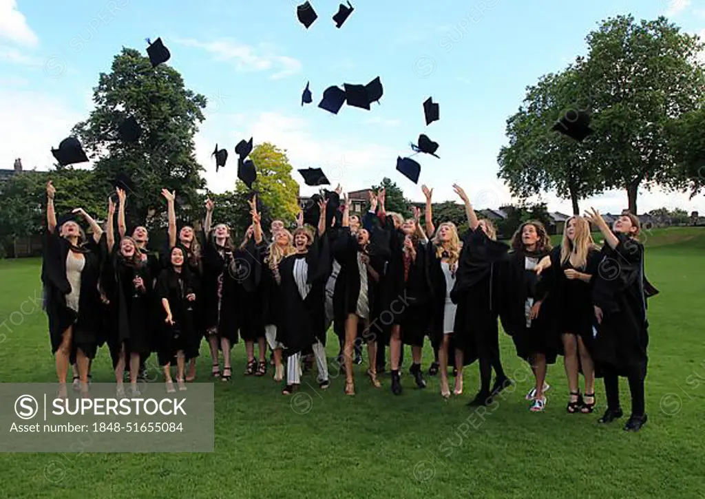 Graduates in gowns throwing their mortarboards into the air, Goldsmiths, University of London, England, UK