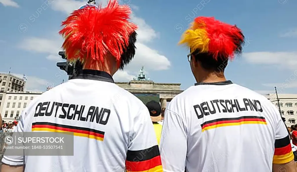 Football fans wear wigs with the colours of the German flag for the World Cup opening match between Germany and Mexico in the fan mile at the Brandenburg Gate in Berlin, 17.06.2018