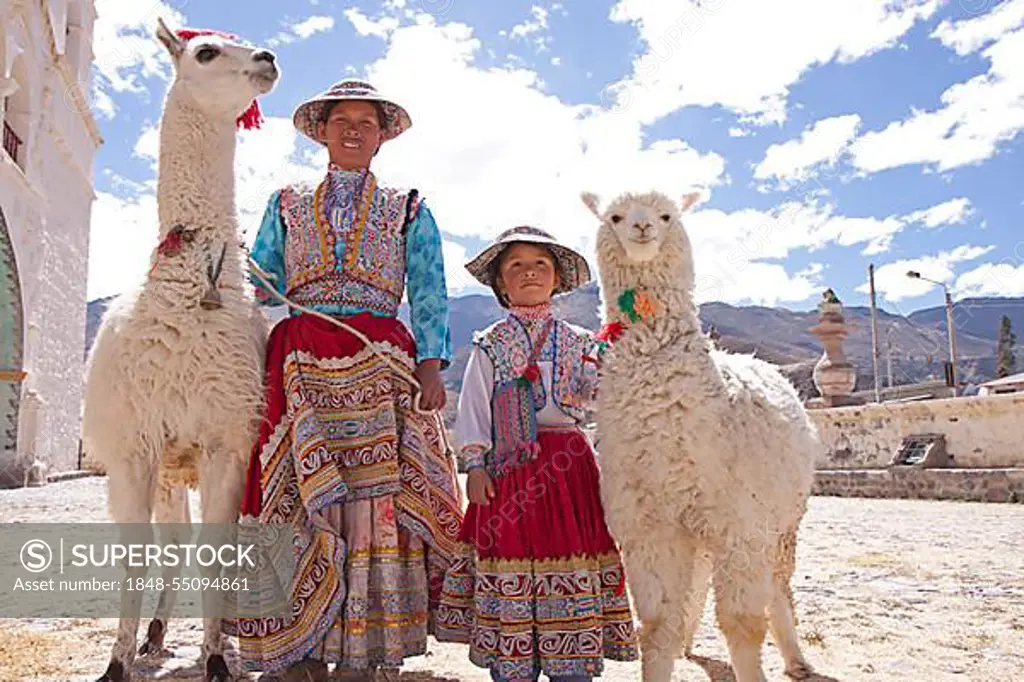 Woman and girl with llama and alpaca in Maca near Colca Canyon, Peru, South America