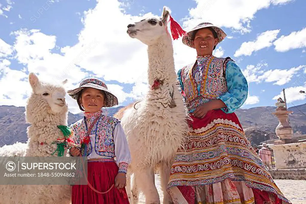 Woman and girl with llama and alpaca in Maca near Colca Canyon, Peru, South America