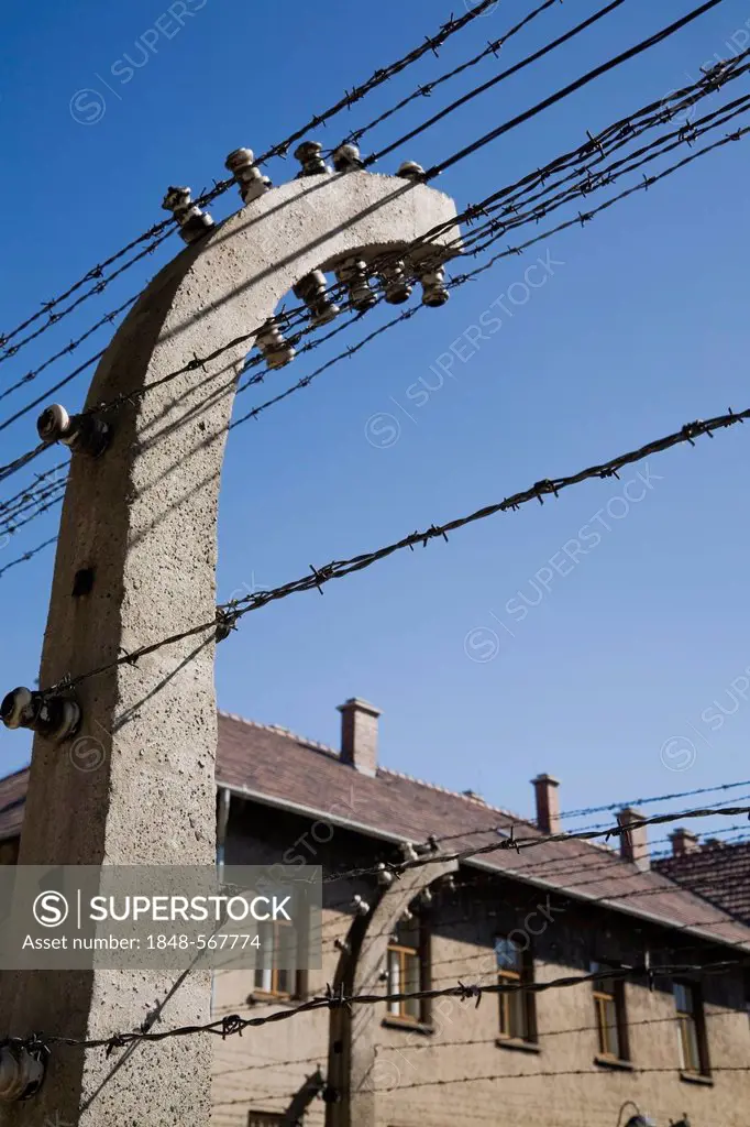 Barb wire electric fence and building inside the Auschwitz I former Nazi Concentration Camp, Auschwitz, Poland, Europe