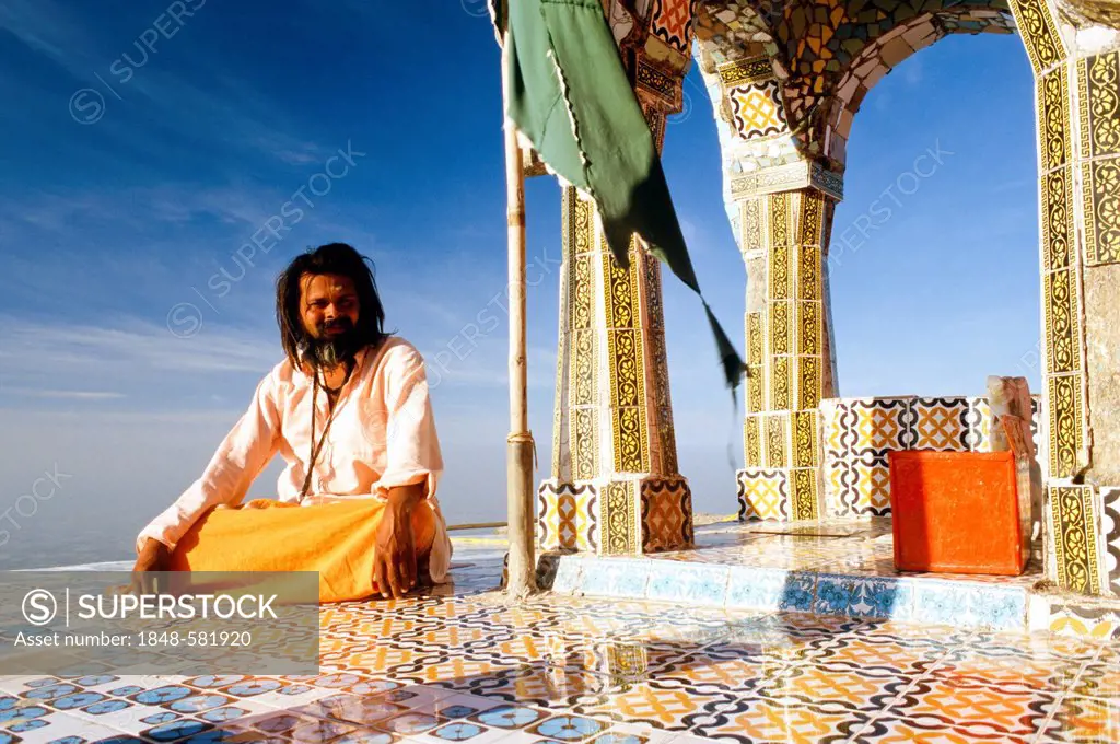 Sadhu taking care of a temple on top of Girnar Hill, Junagadh, Gujarat, India, Asia