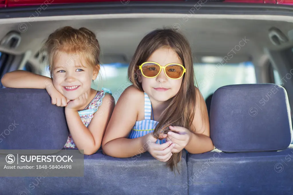 Happy kids in the car. Family on vacation. Summer holiday and car travel concept