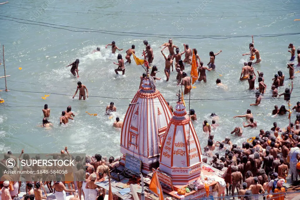 Naked Naga-Sadhus taking a holy bath during the Kumbha or Kumbh Mela in the Ganges River, Har Ki Pauri-Ghat, a famous bathing ghat at Haridwar or Hard...