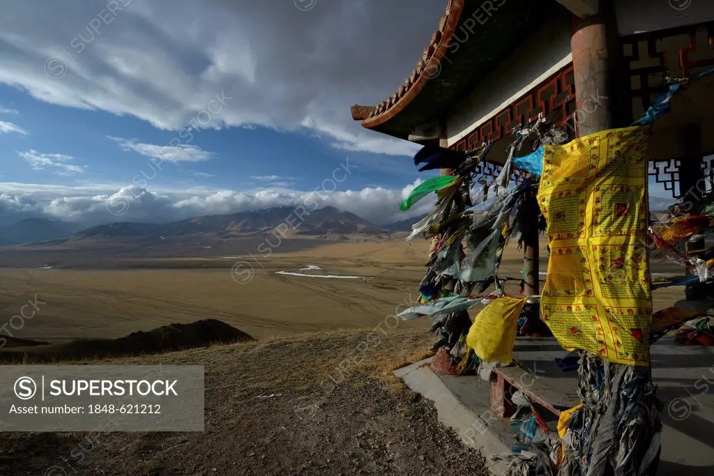 Chinese Mongolian pavilion adorned with Buddhist prayer flags flying in the wind, grasslands of Bayanbulak, Bayingolin Mongol Autonomous Prefecture, K...