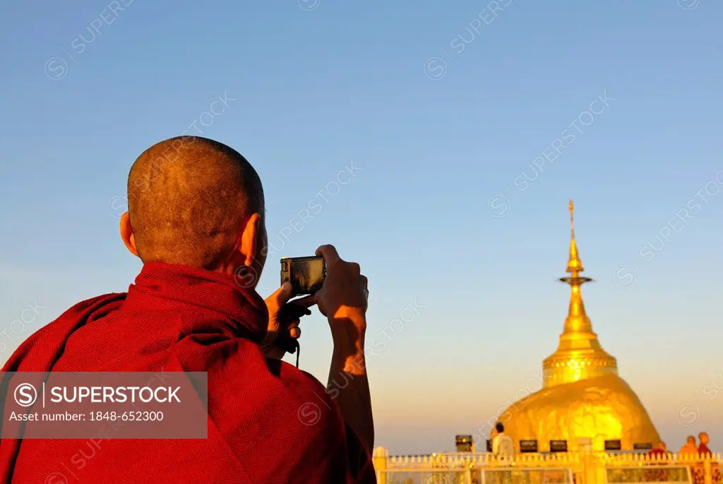 Monk photographing the Kyaiktiyo Pagoda or Golden Rock on his pilgrimage, Kyaiktiyo, Myanmar, Burma, Southeast Asia