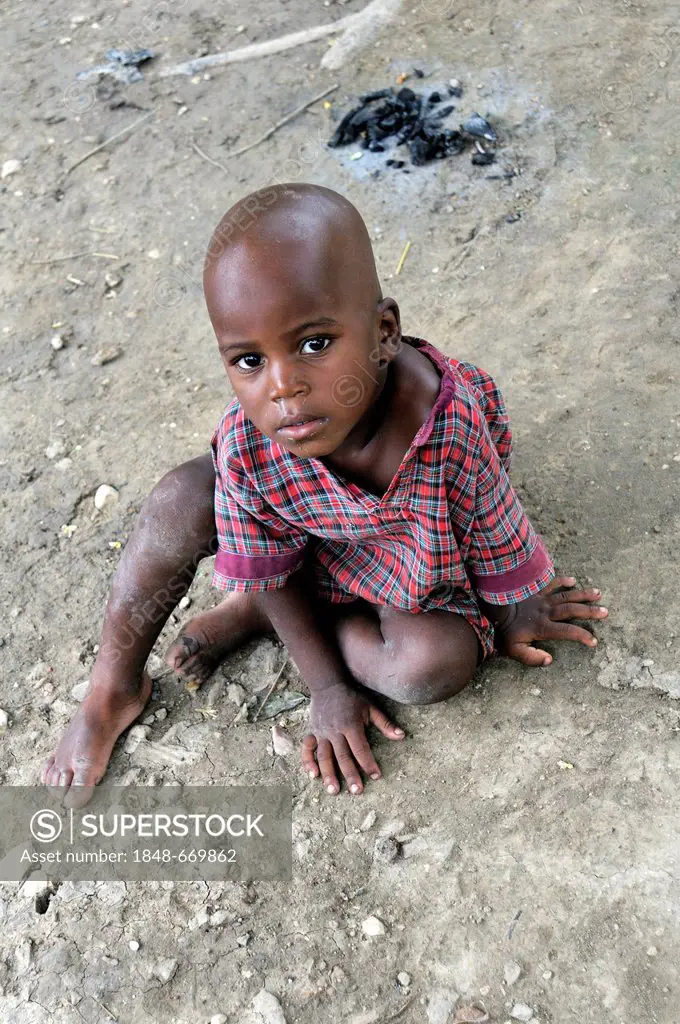 Poor boy sitting on the ground, Port-au-Prince, Haiti, Caribbean, Central America