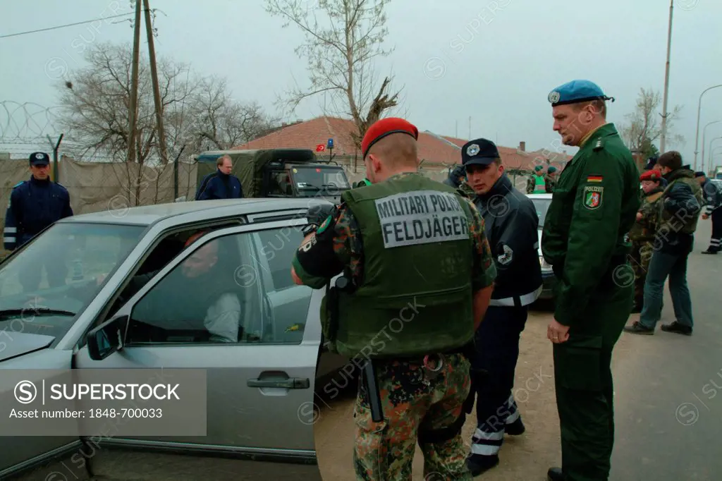 Joint checkpoint of the German KFOR Bundeswehr forces and the international police forces, checking of vehicles and their occupants, deployment of Ger...