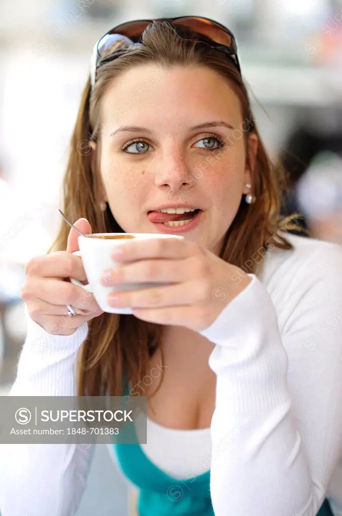 Young woman drinking coffee, holding coffee cup, cafe, Paris, France, Europe