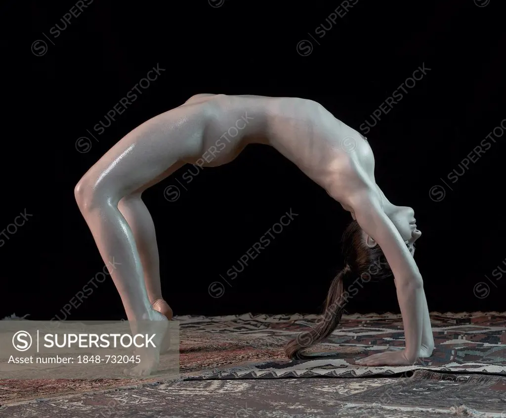 Young woman, upward bow or wheel pose, yoga pose, Chakrasana, nude -  SuperStock