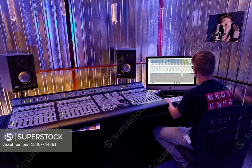 Sound engineer at the mixing desk in a recording studio, music production demonstration of the SAE Institute, IdeenPark 2012, technology and education...