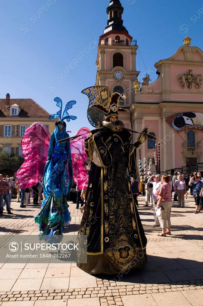 Dancers walking on stilts wearing colorful costumes, Venezianische Messe, Venetian festival, Ludwigsburg, Baden-Wuerttemberg, Germany, Europe