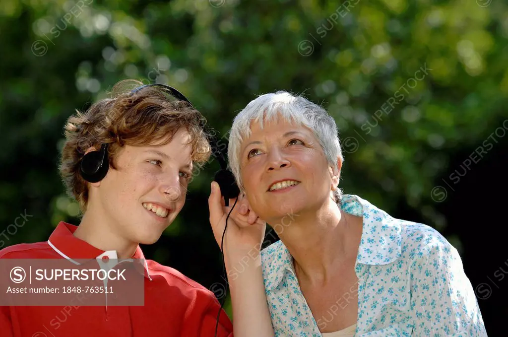 Grandma and grandson with headphones listening to music together