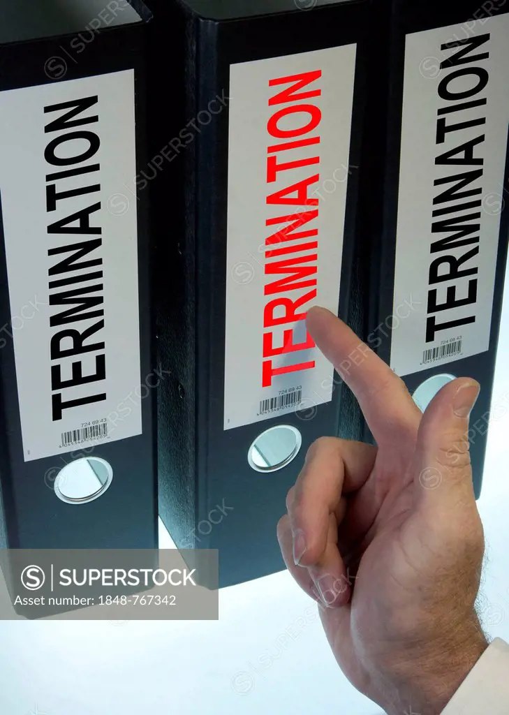 Hand pointing to a ring binder labelled TERMINATION